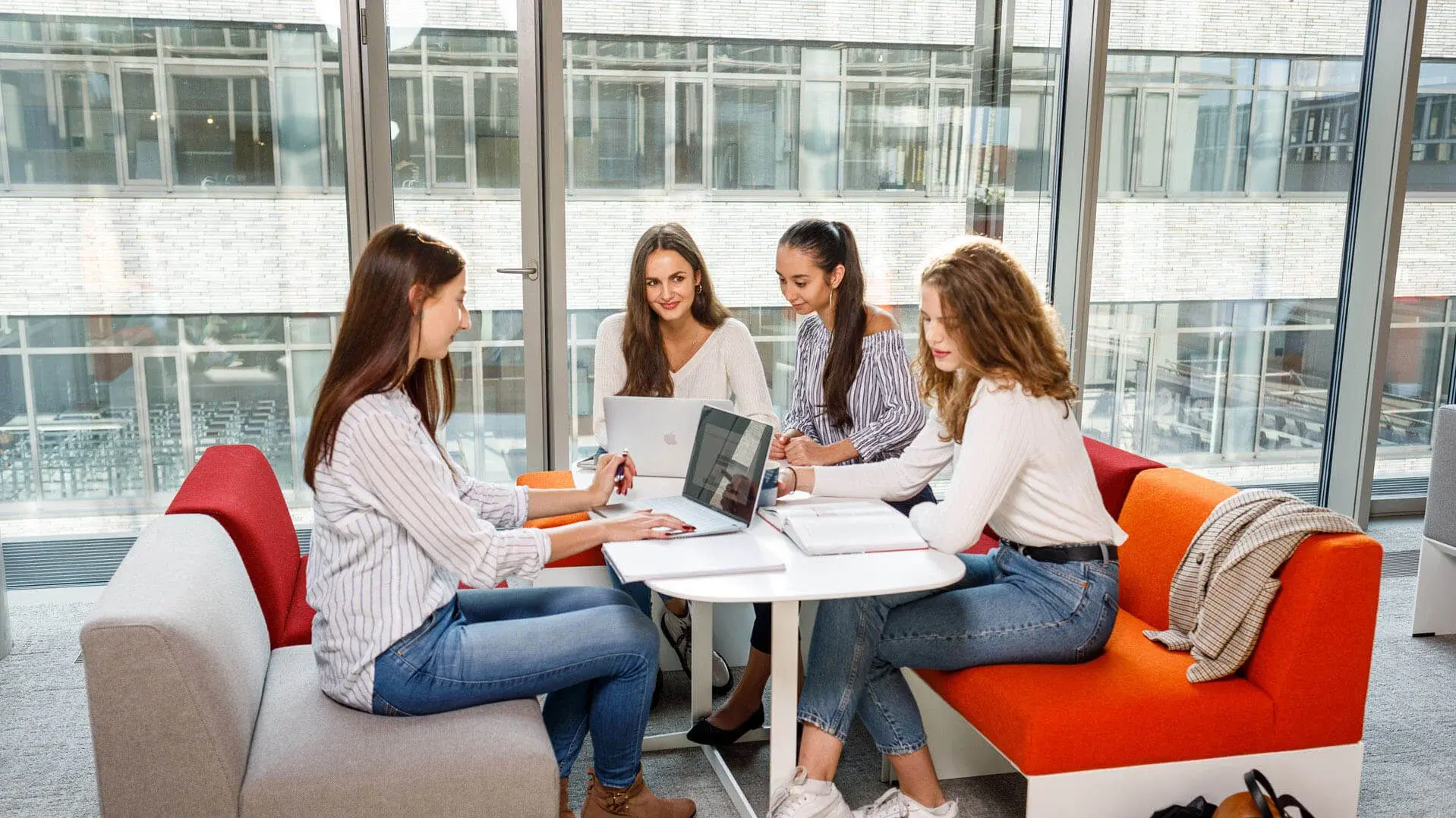 Six students sitting and smiling