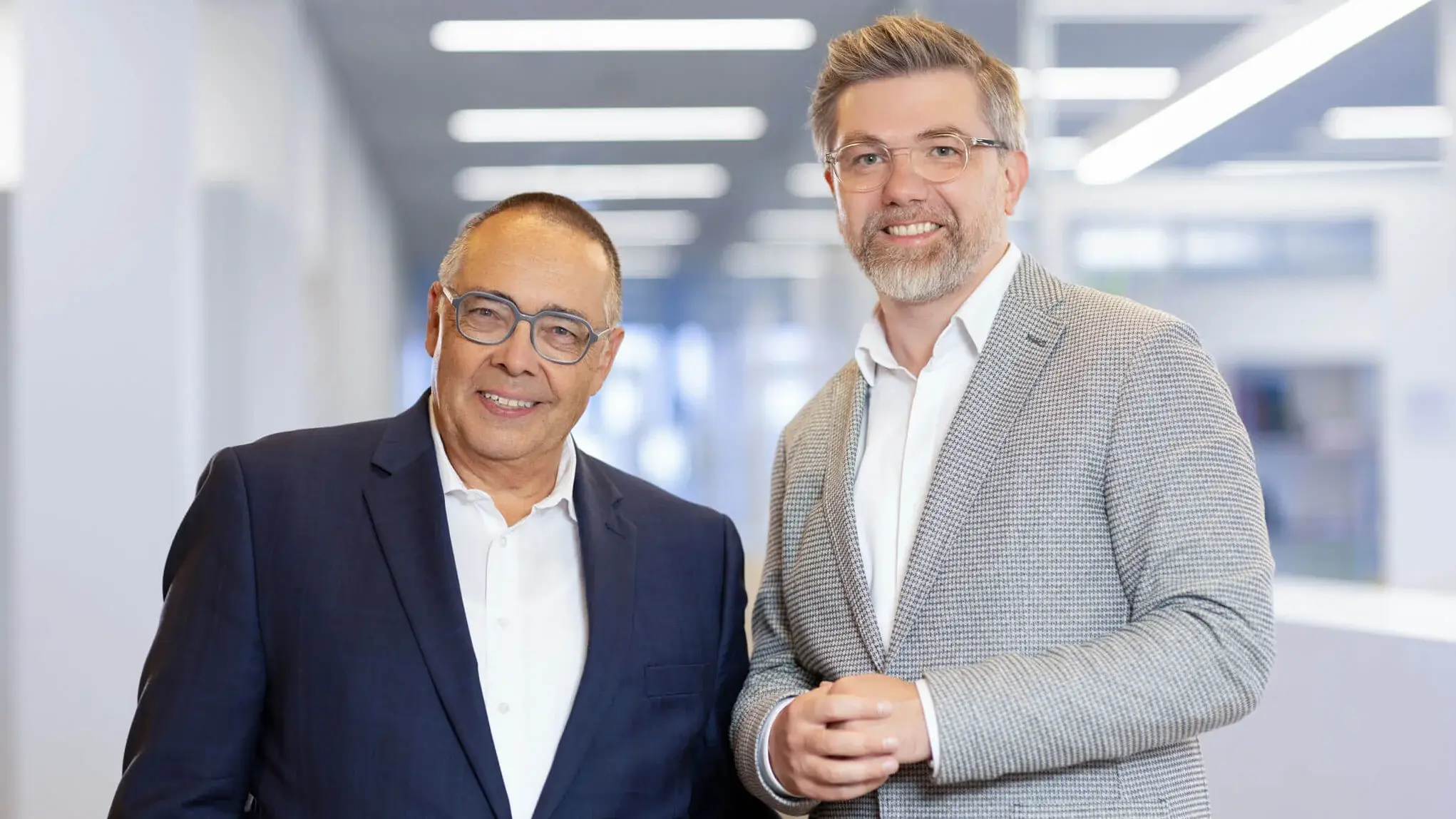 Portrait of two men in professional attire looking at the camera