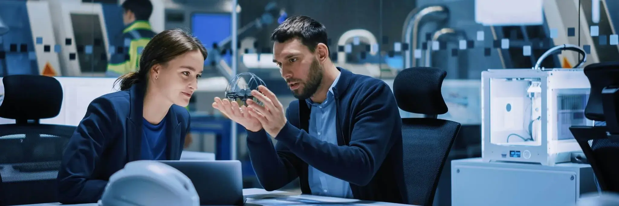 Two people sitting in a technical laboratory