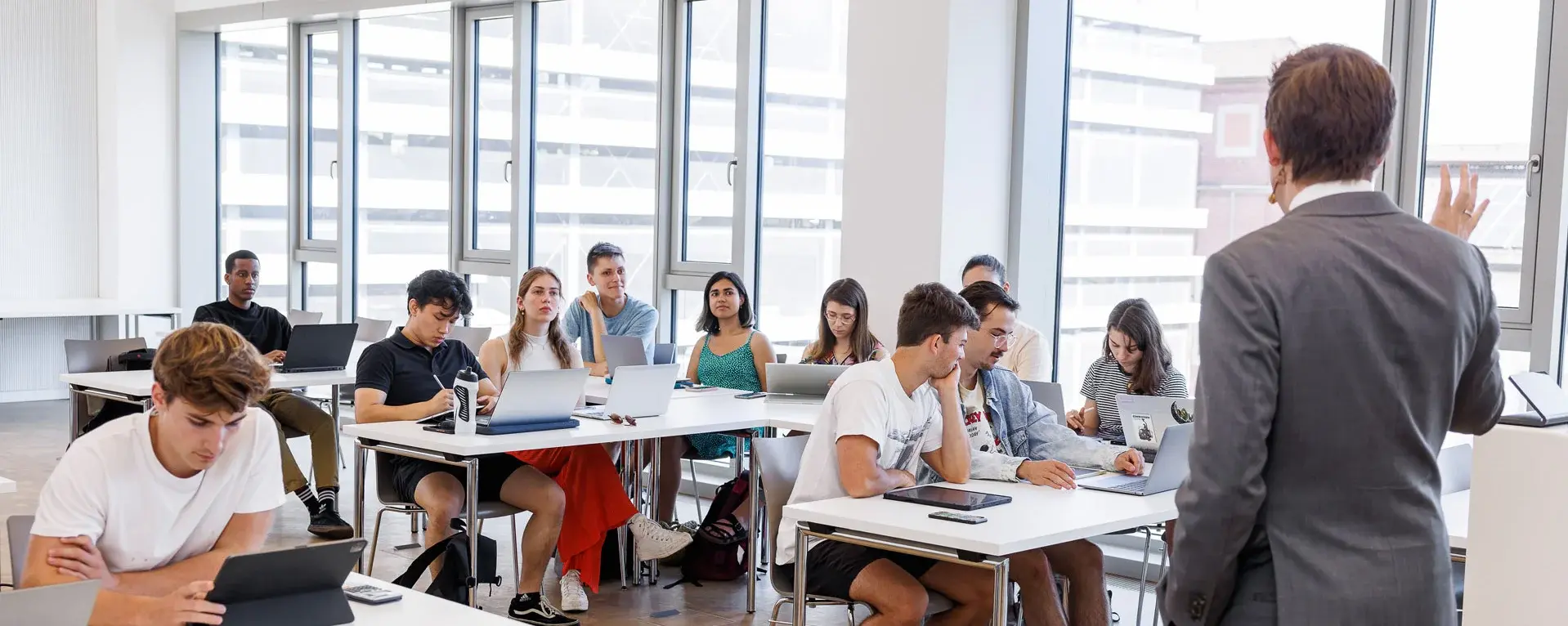 Professor lecturing to a full classroom of students