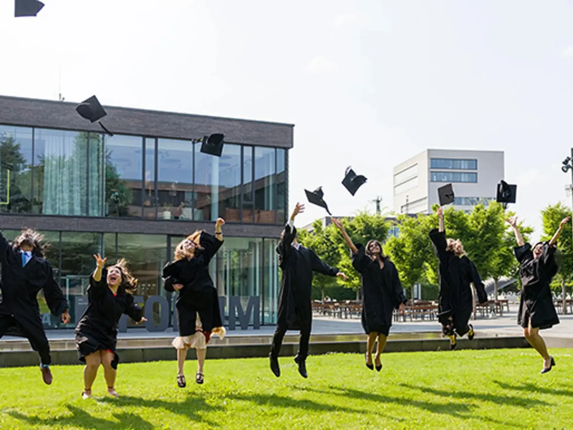 Students throwing their graduation hats in the air