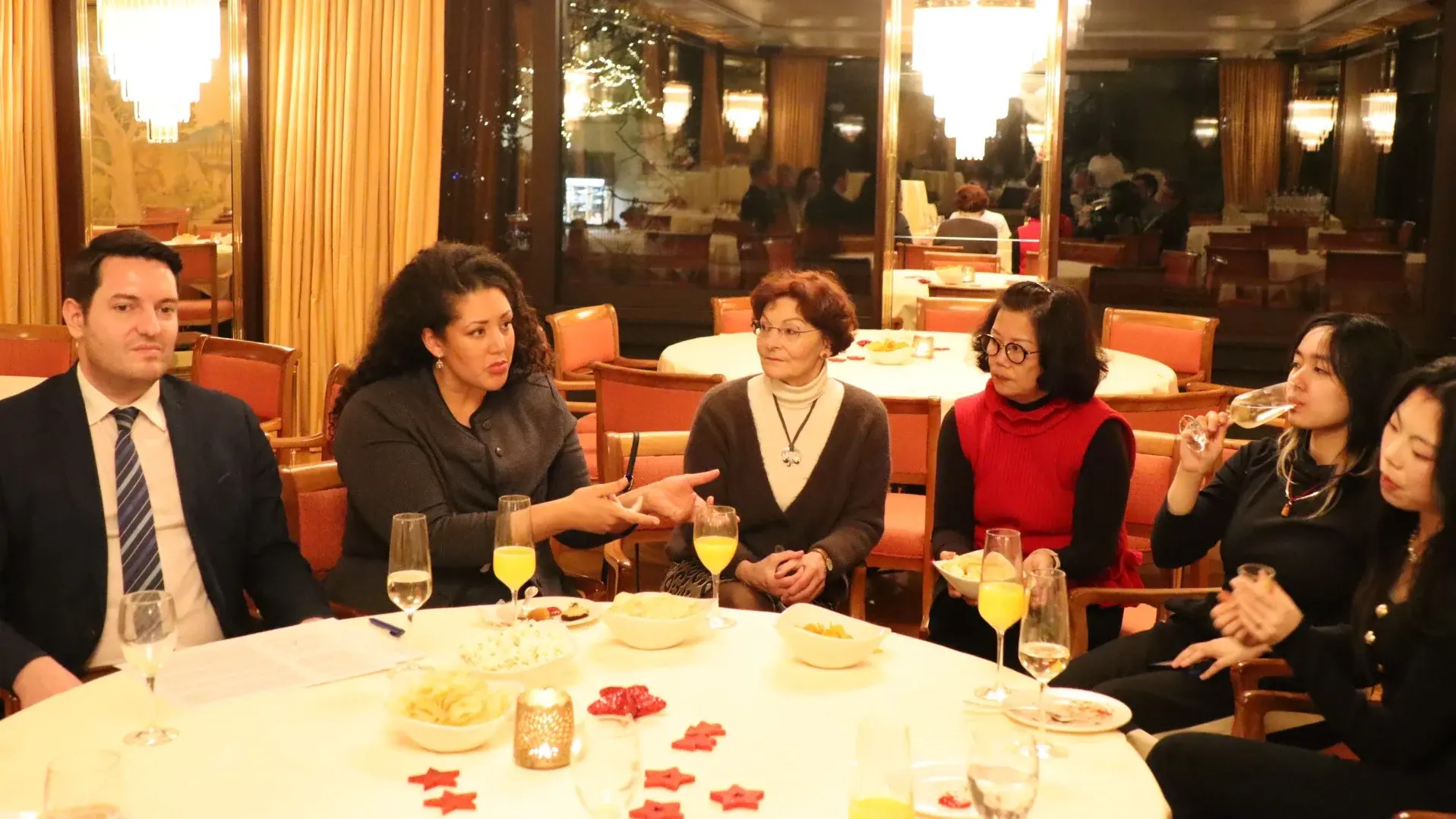 A group of people engaged in discussion around a table.