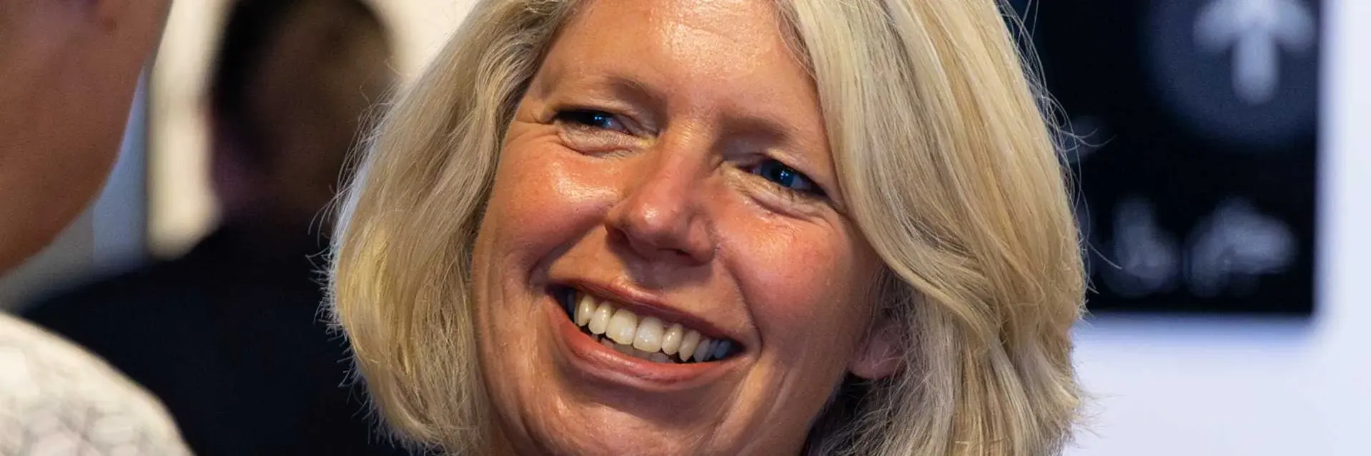 A blond woman in conversation