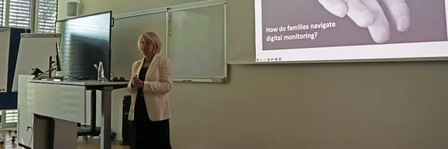 a woman standing in front of a board