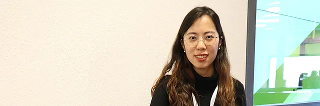 young woman in black sitting at a table