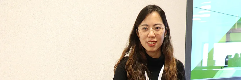 young woman in black sitting at a table