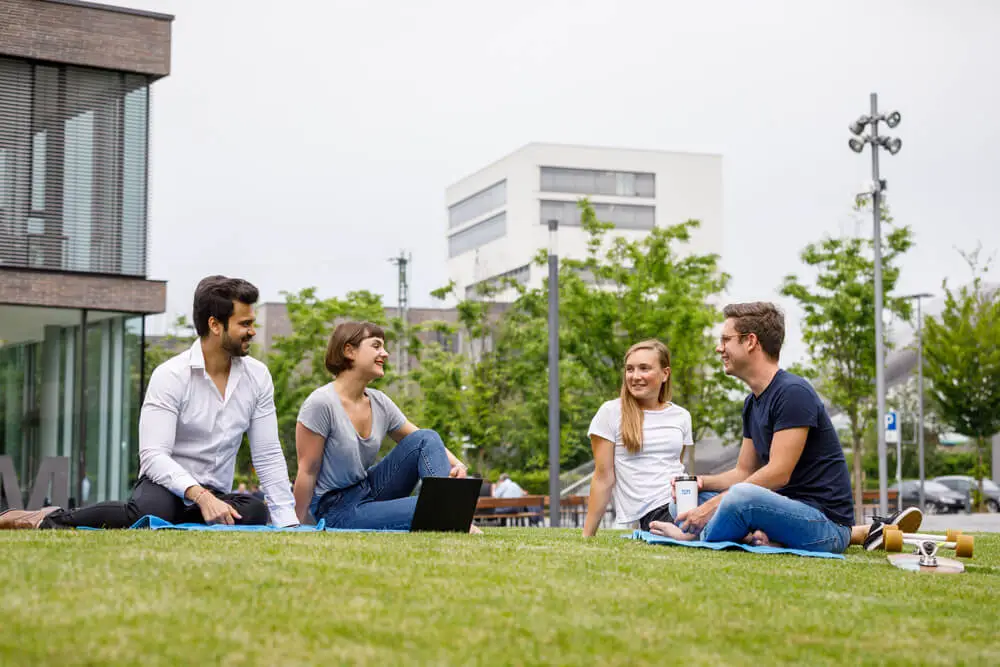 Students sitting on the grass at campus