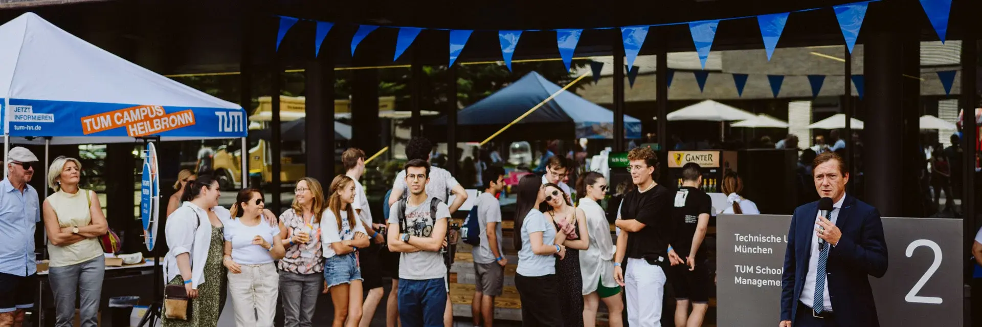 Students in front of campus building at event