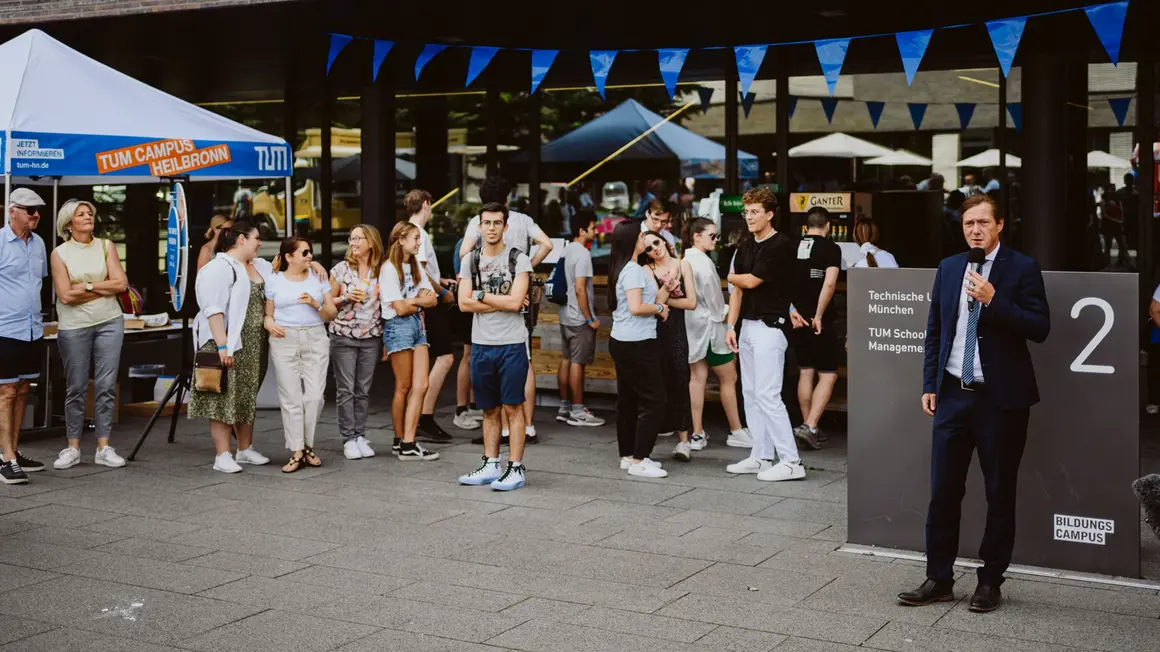 Students in front of campus building at event