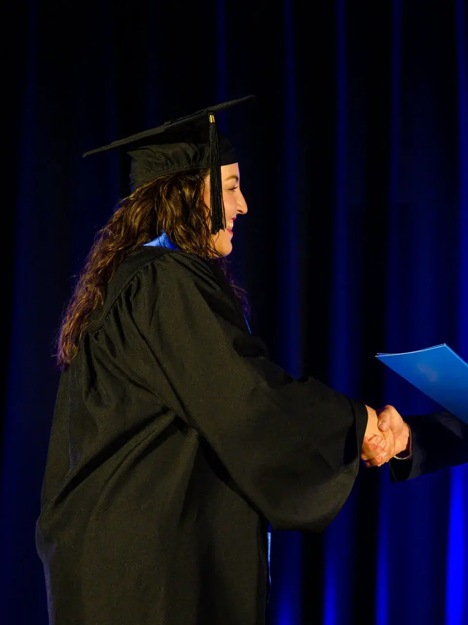 Graduate Pamela receiving graduation prize