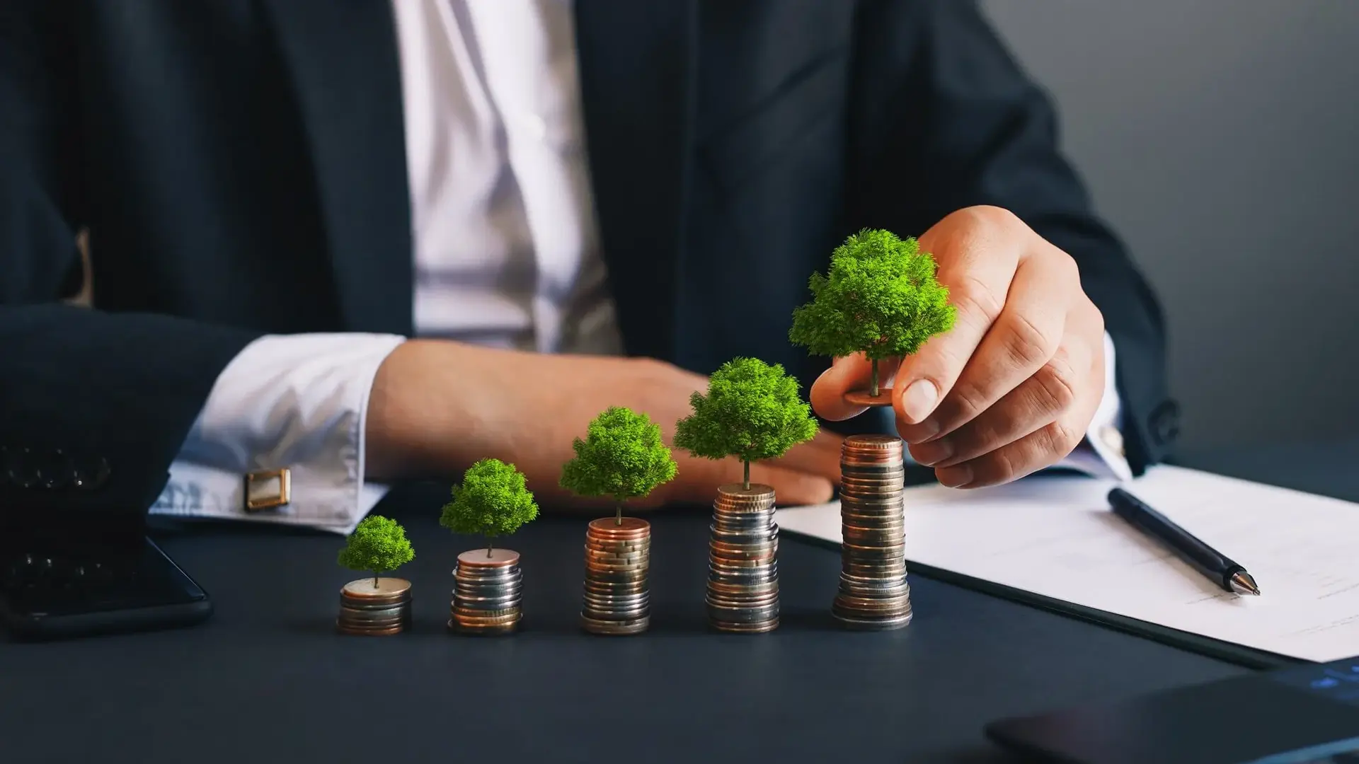 Stacked coins with plastic trees on them