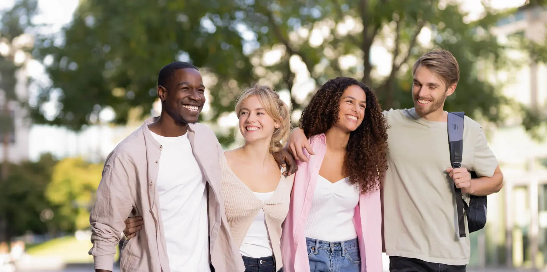 Four students in front of campus