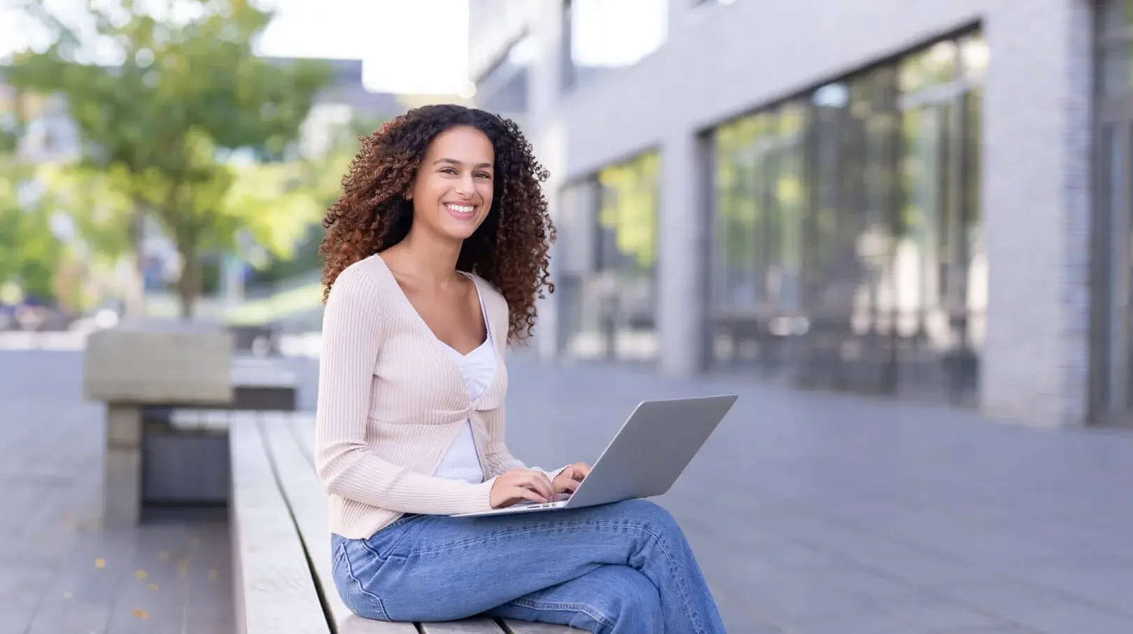 Student working on a laptop outside on campus